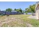 Large backyard featuring a fire pit, fenced yard, and ample space for outdoor activities at 4732 W Wyoming Ave, Tampa, FL 33616