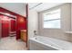 Bright bathroom featuring a soaking tub and a vanity with a sink at 4732 W Wyoming Ave, Tampa, FL 33616