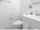 Bathroom featuring white fixtures, including a toilet and vanity with chrome fixtures at 4732 W Wyoming Ave, Tampa, FL 33616
