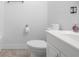 Bathroom featuring white fixtures, including a toilet, vanity, and tiled shower and floors at 4732 W Wyoming Ave, Tampa, FL 33616