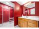 Bathroom features a vanity, mirror, and walk in closet with wire shelving at 4732 W Wyoming Ave, Tampa, FL 33616
