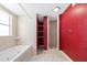 Bathroom featuring a soaking tub, stand-up shower, and storage shelves at 4732 W Wyoming Ave, Tampa, FL 33616