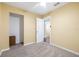 Bedroom with tan walls and carpet flooring with closet at 4732 W Wyoming Ave, Tampa, FL 33616