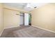 Neutral bedroom with carpet, a ceiling fan, and an open closet area at 4732 W Wyoming Ave, Tampa, FL 33616