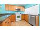 Cozy kitchen with wood cabinets, granite countertops, and stainless steel appliances at 4732 W Wyoming Ave, Tampa, FL 33616
