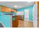 Bright kitchen boasts natural wood cabinetry, modern appliances and seamless flow to other living spaces at 4732 W Wyoming Ave, Tampa, FL 33616