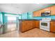 Cozy kitchen with wooden cabinets, modern appliances and an adjacent dining area at 4732 W Wyoming Ave, Tampa, FL 33616