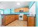 Well-equipped kitchen features wood cabinets, granite countertops, and modern appliances for a functional cooking space at 4732 W Wyoming Ave, Tampa, FL 33616