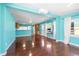 Open-concept living area flowing into the kitchen, featuring hardwood floors and natural light from windows at 4732 W Wyoming Ave, Tampa, FL 33616