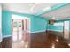Bright living room features wood floors, abundant natural light, and views of the backyard patio at 4732 W Wyoming Ave, Tampa, FL 33616