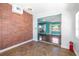Bright living room features exposed brick, tile floors and an open view of the adjacent living area at 4732 W Wyoming Ave, Tampa, FL 33616
