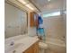 Well-lit bathroom featuring a large mirror, vanity, and tiled shower/tub combination at 4848 Quill Ct, Palm Harbor, FL 34685