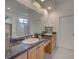 Bathroom featuring double sinks, granite countertops, a large mirror, and custom cabinetry at 4848 Quill Ct, Palm Harbor, FL 34685