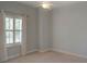 Bedroom with light blue walls, bright window, and neutral carpeting at 4848 Quill Ct, Palm Harbor, FL 34685