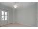 Clean bedroom with light paint, plush carpet, ceiling fan, and window with plantation shutters at 4848 Quill Ct, Palm Harbor, FL 34685