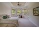 Bright Primary bedroom with a tray ceiling, large windows, and a door to the pool area at 4848 Quill Ct, Palm Harbor, FL 34685