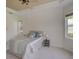 Comfortable bedroom with neutral carpeting, a ceiling fan, and natural light from the surrounding windows at 4848 Quill Ct, Palm Harbor, FL 34685