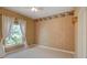 Bright bedroom with carpet, neutral color palette, and large window at 4848 Quill Ct, Palm Harbor, FL 34685