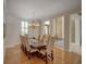 Elegant dining area with wood floors, a large dining table, and decorative chandelier near the entryway at 4848 Quill Ct, Palm Harbor, FL 34685
