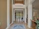 Inviting foyer showcasing soaring ceilings, hardwood floors, and an open floor plan with views to the living area at 4848 Quill Ct, Palm Harbor, FL 34685