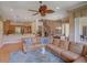 Open-concept living room with hardwood floors, a large sectional, and views of the staircase and dining area at 4848 Quill Ct, Palm Harbor, FL 34685