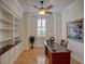 Bright home office with custom built-ins, hardwood floors, and a large window for natural light at 4848 Quill Ct, Palm Harbor, FL 34685