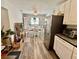 Bright eat-in kitchen with wood look floors, white cabinets, stainless appliances, and lots of natural light at 5045 2Nd S Ave, St Petersburg, FL 33707