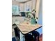 Bright kitchen featuring a unique countertop island, white cabinets and a lovely accent plant at 5045 2Nd S Ave, St Petersburg, FL 33707