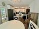 This is a cozy kitchen nook with stainless steel appliances, white cabinets, and wood-look floors at 5045 2Nd S Ave, St Petersburg, FL 33707