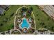 Aerial view of a community pool surrounded by lush landscaping and condo buildings at 5108 Brittany S Dr # 607, St Petersburg, FL 33715