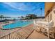 Balcony view of the community pool and bay with outdoor table and chairs at 5108 Brittany S Dr # 607, St Petersburg, FL 33715