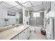 Well lit bathroom featuring a tiled shower, white vanity and neutral color palette at 5108 Brittany S Dr # 607, St Petersburg, FL 33715