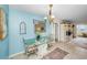 Charming dining area featuring a glass table, unique seating, and beach themed decor at 5108 Brittany S Dr # 607, St Petersburg, FL 33715
