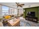 Comfortable living room with plenty of seating, ceiling fan, and views of the bay from the balcony at 5108 Brittany S Dr # 607, St Petersburg, FL 33715