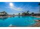 A large beautiful outdoor swimming pool with blue water, lounge chairs and umbrellas at a tropical resort at 5108 Brittany S Dr # 607, St Petersburg, FL 33715