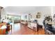 Spacious living room featuring a large workspace, wood floors, neutral walls, and a view of the outdoor patio at 5150 10Th N Ave # 310A, St Petersburg, FL 33710