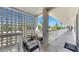 Hallway exterior patio with outside furniture overlooking landscaped grounds and blue skies at 5150 10Th N Ave # 310A, St Petersburg, FL 33710