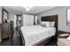 This comfortable bedroom includes a large bed, dark hardwood floors, closet and adjoining bathroom at 5474 77Th N Ave, Pinellas Park, FL 33781