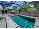 Serene pool and outdoor area featuring lush landscape and a storage shed, enclosed by screened lanai at 5474 77Th N Ave, Pinellas Park, FL 33781