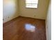 Empty bedroom with wood-look flooring and a window for natural light at 5720 13Th N Ave # 106B, St Petersburg, FL 33710