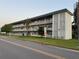 Condo complex with white block design on the side with 3 stories of residences at 5720 13Th N Ave # 106B, St Petersburg, FL 33710