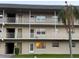 Three-story condo complex with balconies, palm trees and tan paint and white railings at 5720 13Th N Ave # 106B, St Petersburg, FL 33710