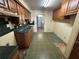 Vintage kitchen with wooden cabinets, tiled floors and countertops and a double sink at 5720 13Th N Ave # 106B, St Petersburg, FL 33710