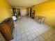Large living area with tile floors, bright yellow walls and lots of space at 5720 13Th N Ave # 106B, St Petersburg, FL 33710