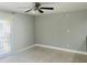 Light-filled living room featuring tile flooring, ceiling fan, and sliding glass doors at 5820 N Church Ave # 212, Tampa, FL 33614