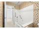 Bathroom featuring floral wallpaper, a combined tub/shower, and grab bars at 6160 29Th N Ave, St Petersburg, FL 33710