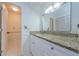 Full bathroom with tile flooring, vanity with granite countertop, and walk-in closet at 70 Ashley Ln, Oldsmar, FL 34677