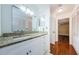 Bright bathroom featuring granite countertops and white cabinetry for a clean, modern aesthetic at 70 Ashley Ln, Oldsmar, FL 34677