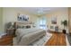 Bedroom with hardwood floors, neutral paint, ceiling fan, and sliding glass door to patio at 70 Ashley Ln, Oldsmar, FL 34677