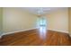 Bedroom with hardwood floors, neutral paint, ceiling fan, and sliding glass door to patio at 70 Ashley Ln, Oldsmar, FL 34677